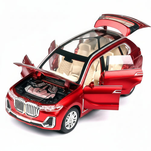 Red toy car with open doors and hood on a white background