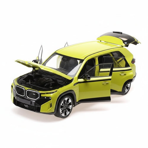 Model car of a green SUV with open doors and hood on a white background