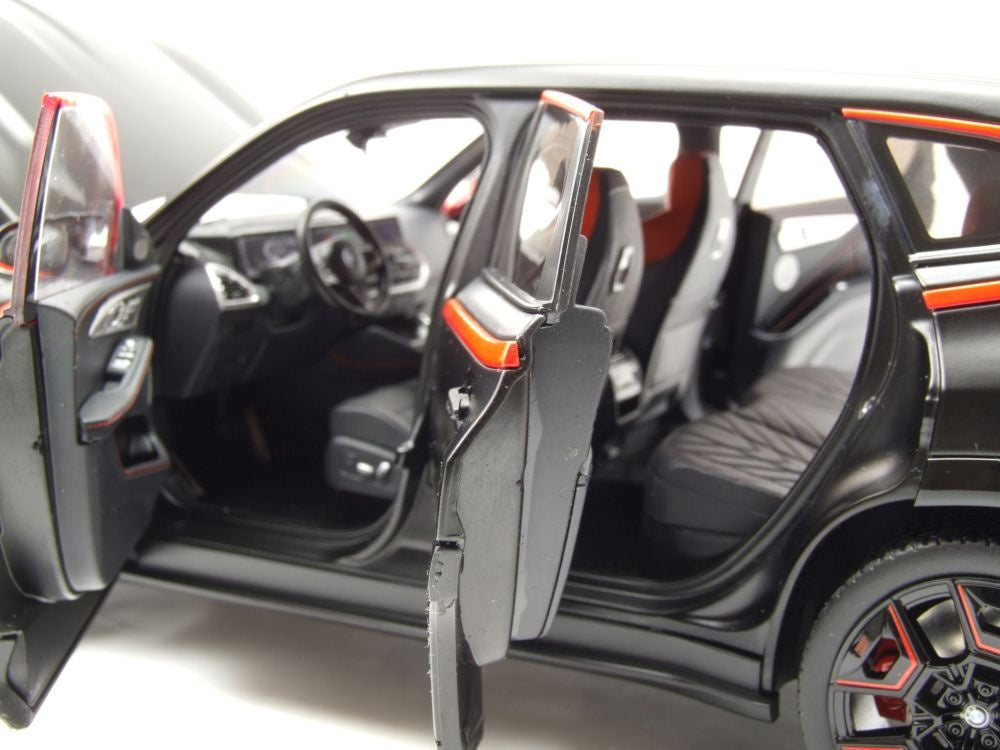 Model car with open doors on a white background