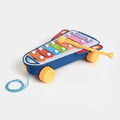 Colorful toy xylophone with a stick on a light gray background