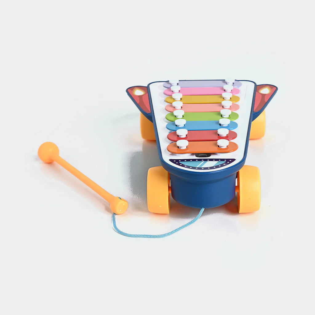 Colorful toy piano with wheels and a pull string on a white background