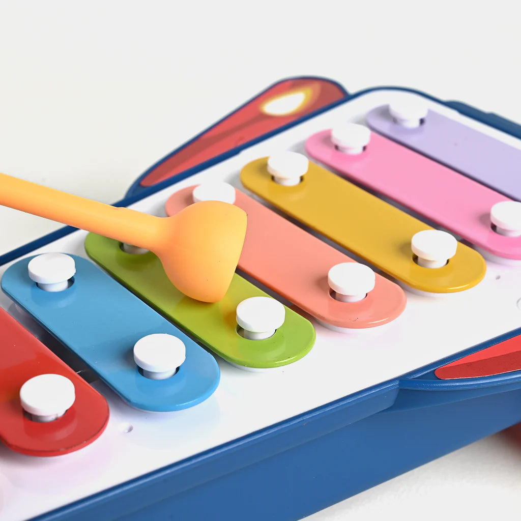 Colorful xylophone toy with a wooden spoon on a white background