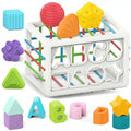 Colorful toy cube with letters and shapes on a white background