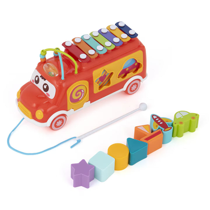 Colorful toy fire truck with pull string and shape sorter on a white background