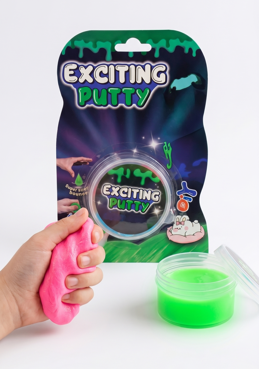 Green putty with packaging and a hand holding a pink putty item on a white background